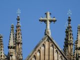 Gothic-style church rooftop cross and spires with heavy ornamentation