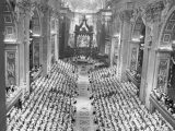 This is a general view of the central nave of Saint Peter's Basilica, transformed into the "hall" of the Roman Catholic Ecumenical Council, during the opening ceremony of the Council on Oct. 11, 1962 in Rome.  All the Council Fathers have taken their seats in the stands erected left and right, while Pope altar, under Bernini's huge bronze canopy, is seen in far background.  (AP Photo/Leslie Priest)